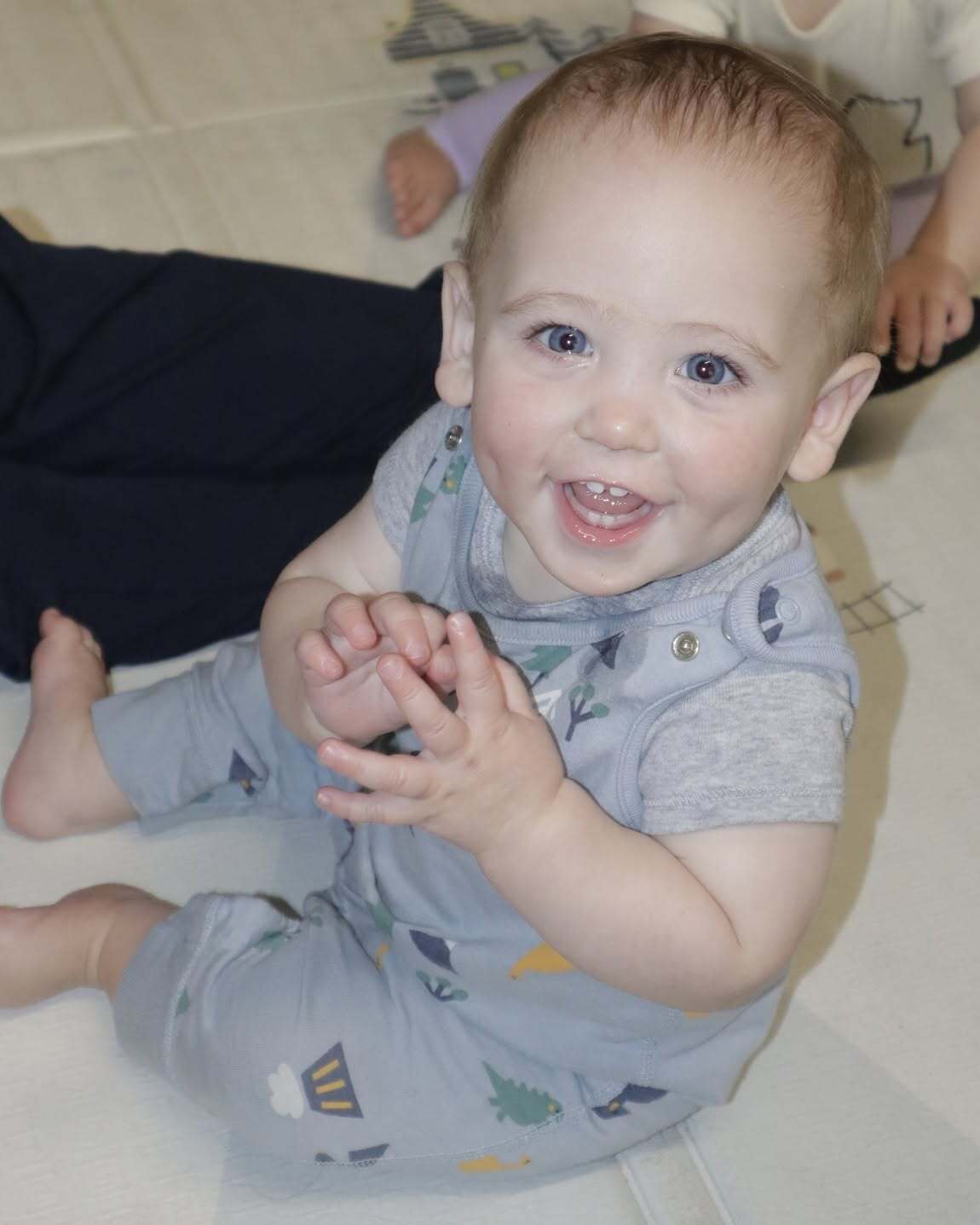 Smiling infant during floor play at World of Wonder